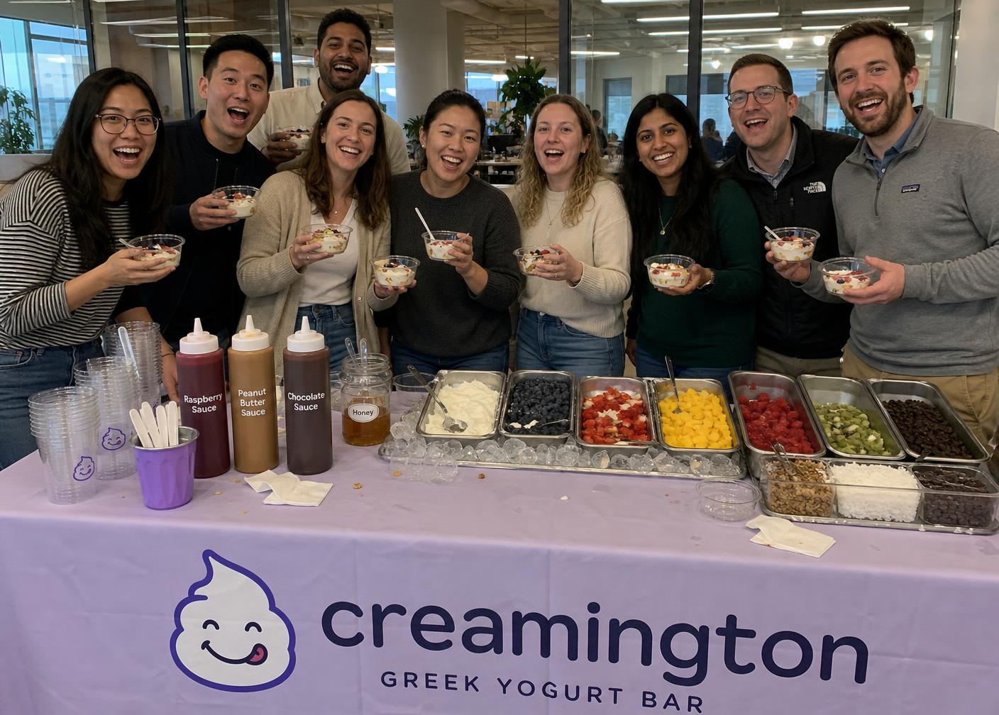Office team smiling in front of the Creamington yogurt bar
